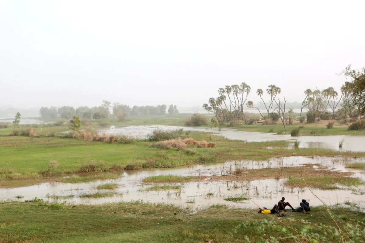 Men rest on the banks of the Niger River in Niamey, Niger, on Feb. 20, 2016. (Joe Penney/Reuters)