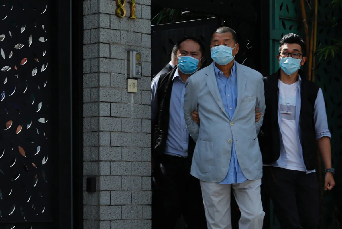Media mogul Jimmy Lai Chee-ying, founder of Apple Daily (C) is detained by the national security unit in Hong Kong on Aug. 10, 2020. (Tyrone Siu/Reuters)