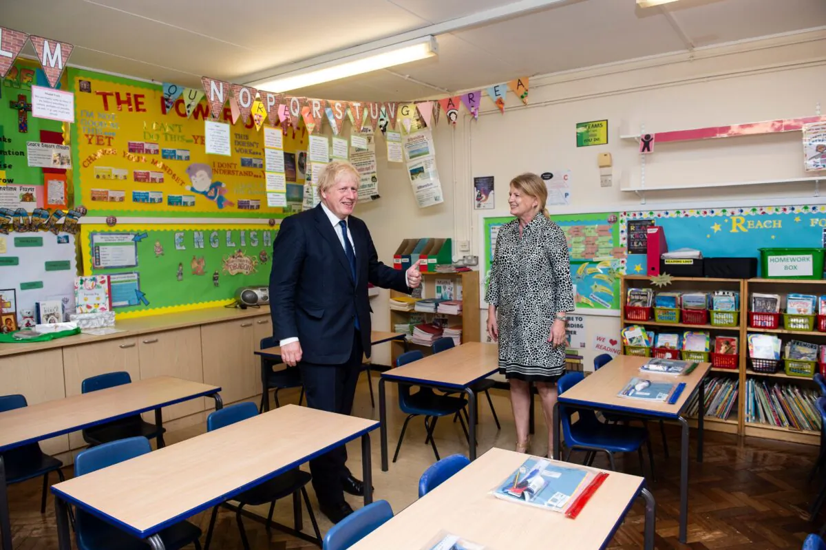 Britain's Prime Minister Boris Johnson (L) talks with head teacher Bernadette Matthews (R) as he visits St Joseph's Catholic Primary School in Upminster, East London, on Aug. 10, 2020. (Lucy Young/Pool/AFP via Getty Images)