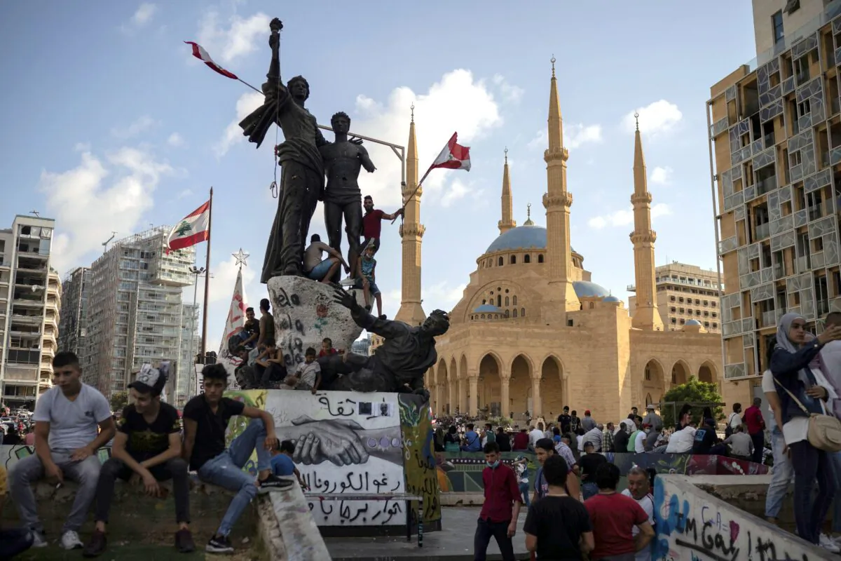 People gather at Martyrs' Square in Beirut as demonstrators took to the streets to protest against government corruption following the deadly explosion that devastated large parts of the city, in Lebanon on Aug. 9, 2020. (AP Photo/Felipe Dana)