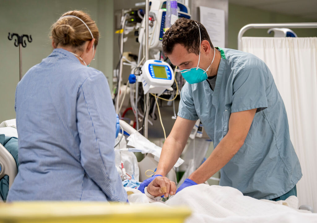 In this handout released by the U.S. Navy, Lt. Wade Miller, from Orlando, Fla., treats a patient aboard the hospital ship USNS Mercy (T-AH 19) in Los Angeles on April 4, 2020. (Ryan M. Breeden/US Navy via Getty Images)