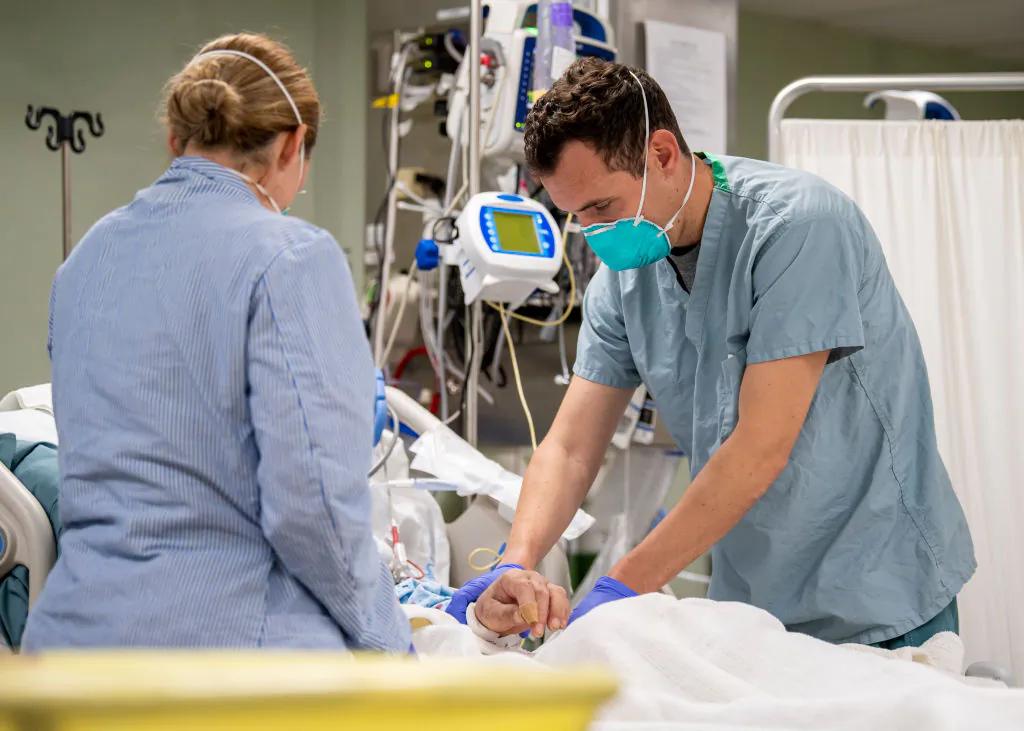 Lt. Wade Miller, from Orlando, Florida, treats a patient aboard the hospital ship USNS Mercy (T-AH 19) in Los Angeles on April 4, 2020. (Ryan M. Breeden/US Navy via Getty Images)