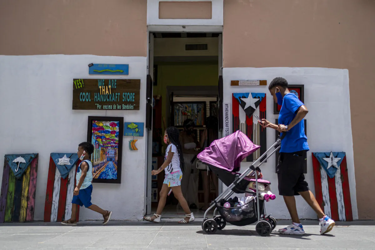 Children walk down a street in Old San Juan, Puerto Rico, on July 20, 2020. (Ricardo Arduengo/AFP via Getty Images)