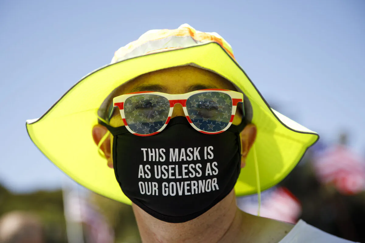 A demonstrator wears a facemask referring to the governor of California in Beverly Hills, Calif., on Aug. 8, 2020. (Patrick T. Fallon/AFP via Getty Images)