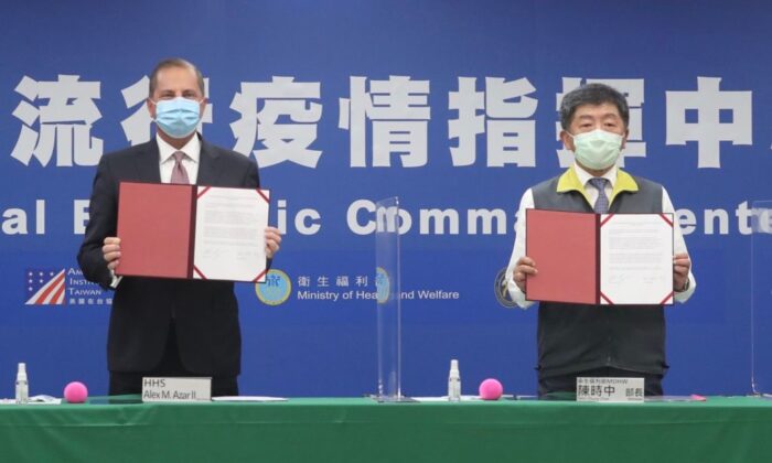 US Health and Human Services Secretary Alex Azar (L) and Taiwan's Minister of Health and Welfare Chen Shih-chung display signed documents at the Central Epidemic Command Center in Taipei on Aug. 10, 2020. (Pei Chen/POOL/AFP via Getty Images)