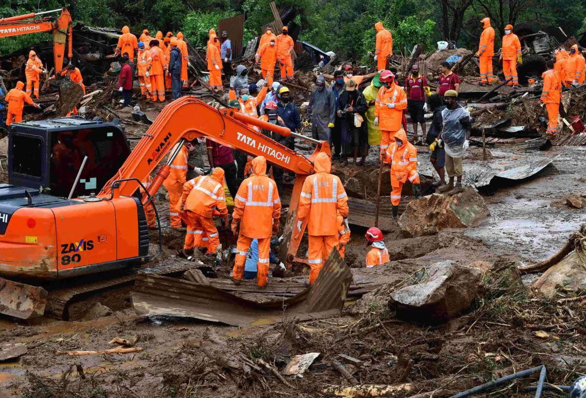 Rescue workers search for missing people at a landslide site caused by heavy rains in Pettimudy, in Kerala state, on Aug. 8, 2020. (STR/AFP via Getty Images)