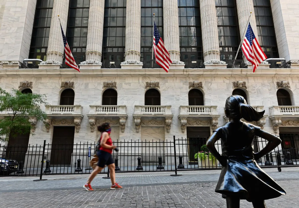 People pass by The New York Stock Exchange on Wall Street in New York City on Aug. 3, 2020. (ANGELA WEISS/AFP via Getty Images)
