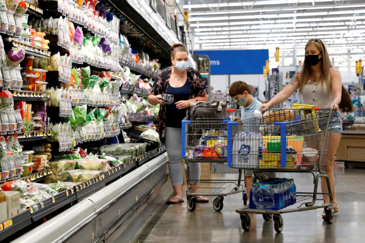 A family wears masks while shopping at a Walmart store in Bradford, Penn., on July 20, 2020. (Brendan McDermid/Reuters)