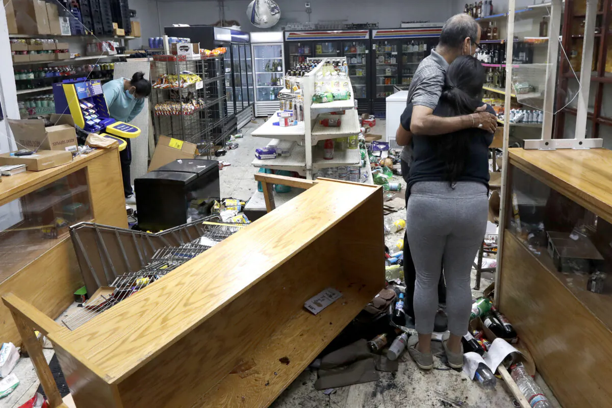 Kajal Dalal walks through her family's food and liquor store after it was vandalized in downtown Chicago Aug. 10, 2020. (Charles Rex Arbogast/AP Photo)