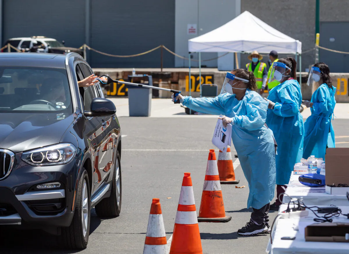 Nurses collect swab tests for COVID-19 at a new, large-scale testing site at the Anaheim Convention Center, in Anaheim, Calif., on July 15, 2020. (John Fredricks/The Epoch Times)