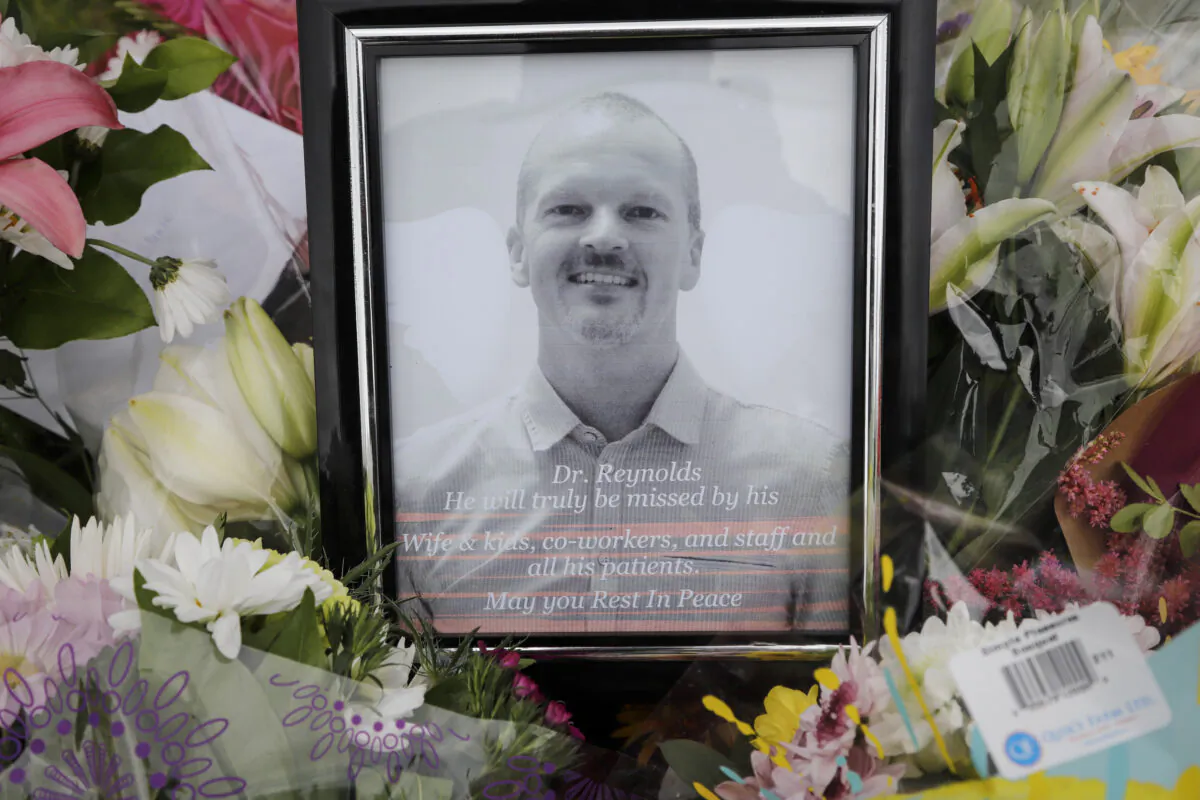 An impromptu memorial for Dr. Walter Reynolds, who died after he was attacked in an examination room rests outside the Village Mall walk-in clinic in Red Deer, Alta., on Aug. 11, 2020. (Jeff McIntosh/The Canadian Press)