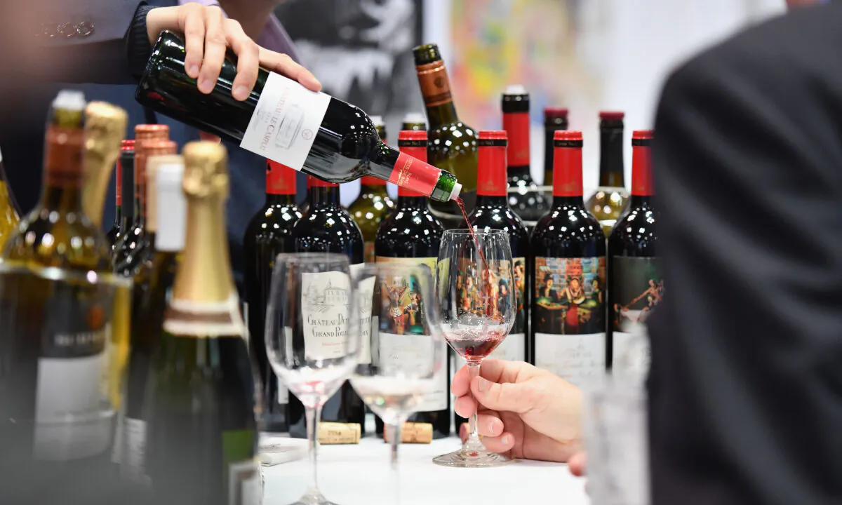 An exhibitor pours red wine during the Vinexpo at Javits Center in New York City on March 2, 2020 in New York City. (Angela Weiss / AFP)
