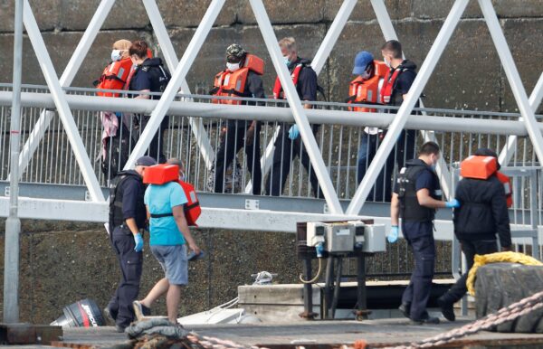 Migrants disembark after arriving at Dover harbour, Britain.