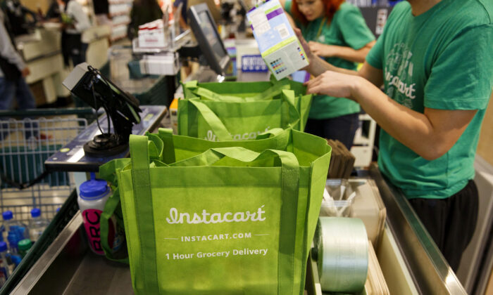 Instacart employees fulfill orders for delivery at the new Whole Foods Market store in downtown Los Angeles on Nov. 9, 2015. (Patrick T. Fallon/Bloomberg Photo via Getty Images)