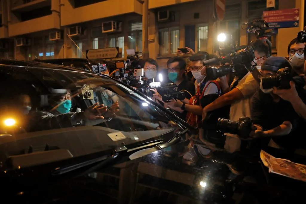 Hong Kong media tycoon and newspaper founder Jimmy Lai, sits in a car as he leaves a police station after being bailed out in Hong Kong on Aug. 12, 2020. The rounding up of the paper’s founder Jimmy Lai, the previous day and a raid on its headquarters have reinforced fears that a new national security law will be used to suppress dissent in Hong Kong after months of anti-government protests. (AP Photo/Kin Cheung)