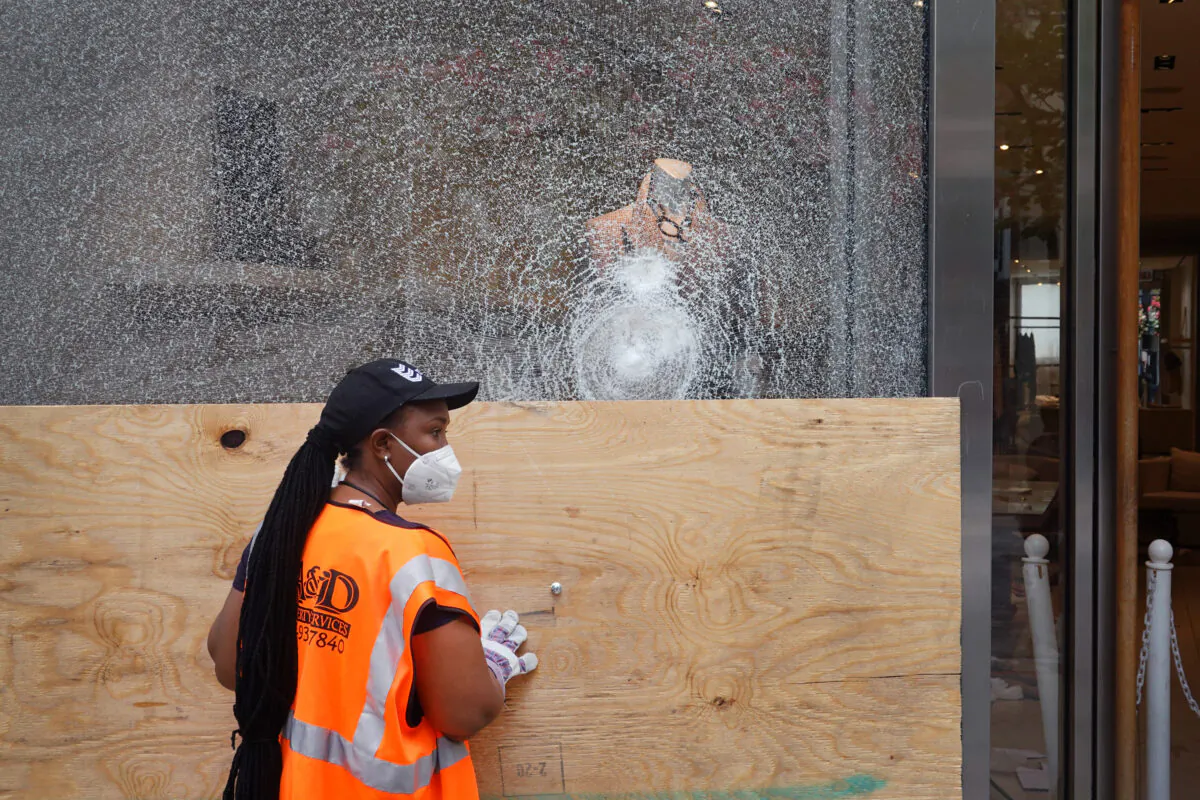 Workers make repairs to the Brunello Cucinelli store after it was looted in Chicago on Aug. 10, 2020. (Scott Olson/Getty Images)