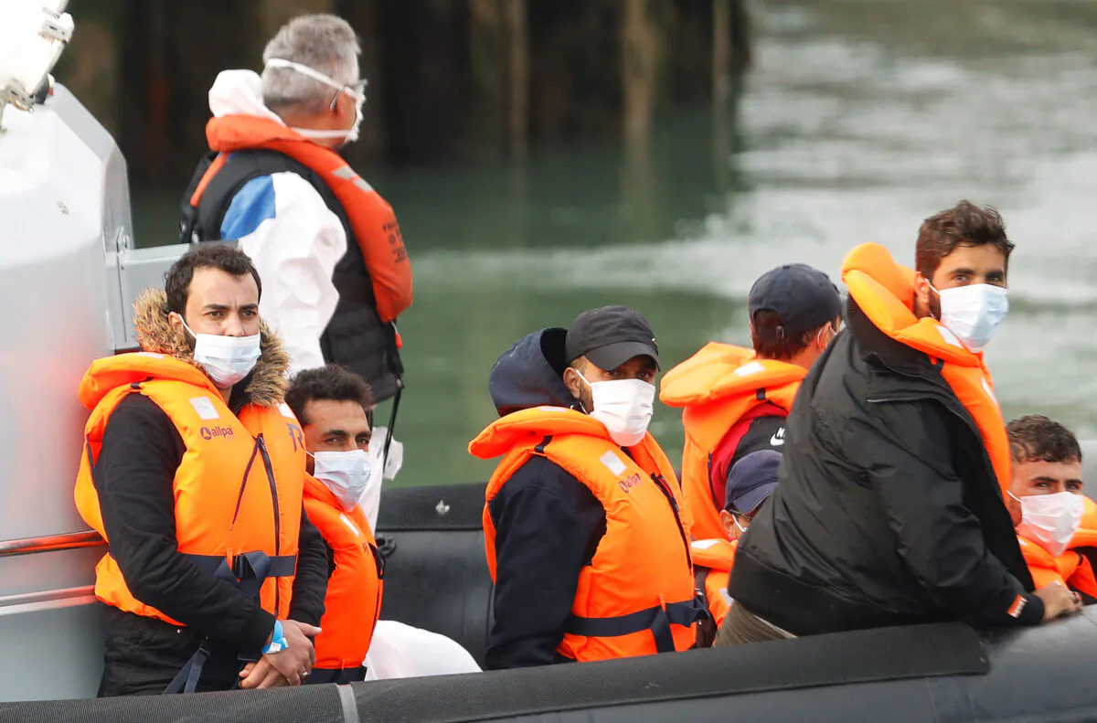 Migrants react as they are brought to Dover harbour by Border Patrol, in Dover, Britain, on Aug. 11, 2020. (Reuters/Peter Nicholls)
