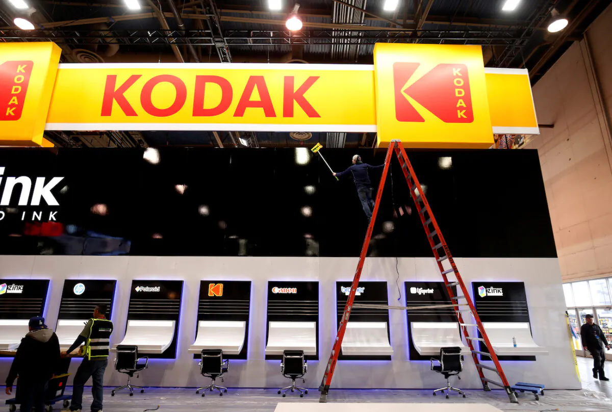A worker cleans a Kodak booth at the Las Vegas Convention Center in preparation for 2019 CES in Las Vegas, Nevada, on Jan. 6, 2019. (Steve Marcus/File Photo/Reuters)