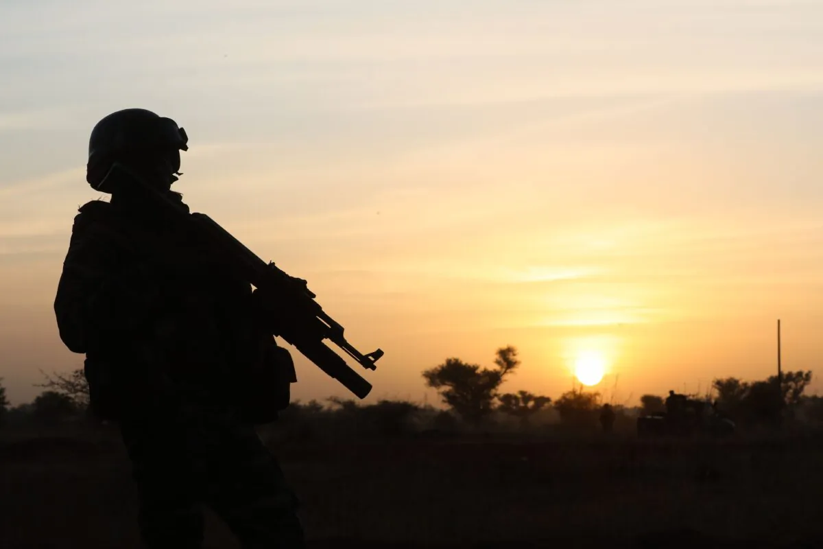 A soldier stands guard at sunset as France's President and Niger's President Mahamadou Issoufou (unseen) take part in a military ceremony at the Martyr Quarter on Dec. 22, 2019. (Ludovic Marin/Pool/AFP via Getty Images)