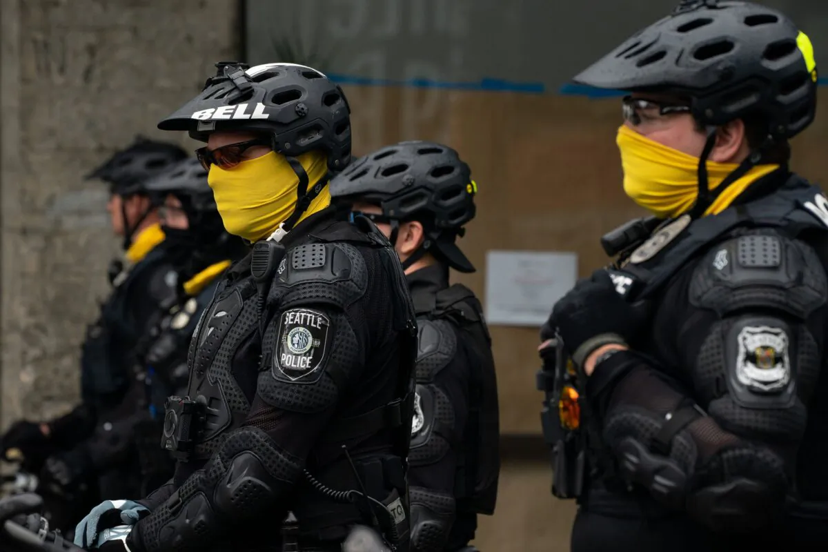 Police officers block a street as city crews dismantle the Capitol Hill Organized Protest (CHOP) area outside of the Seattle Police Department's vacated East Precinct, in Seattle, Wash., on July 1, 2020. (David Ryder/Getty Images)