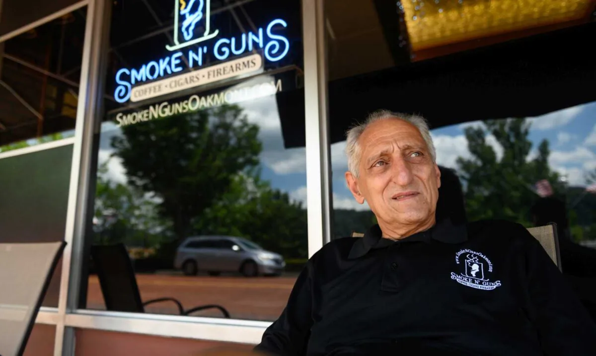 Gregory Ionadi, 75, sits in front of Smoke N’ Guns, which he owns with his son, Gregory ‘Gooch’ Ionadi. (Justin Merriman)