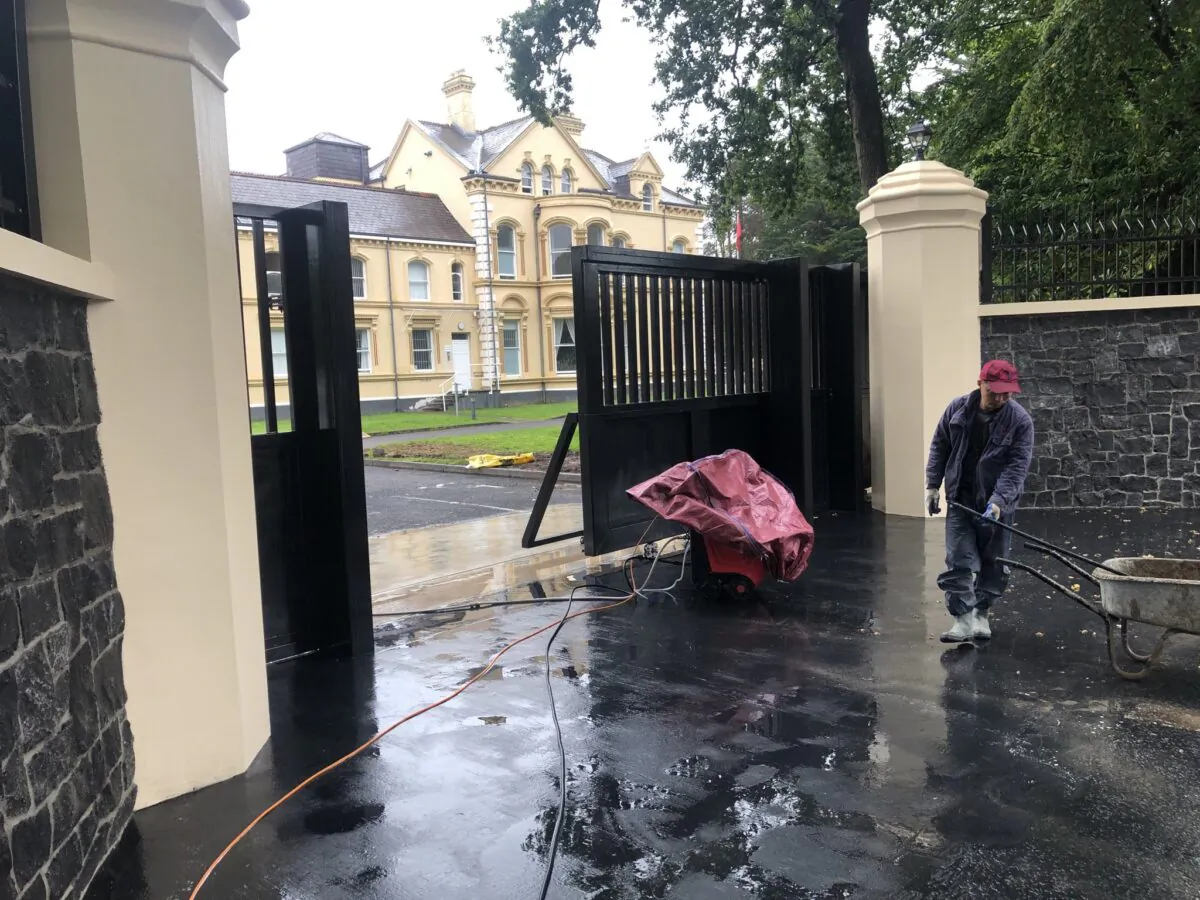 A worker working on a footpath outside the Chinese Consulate in Belfast on July 24, 2020. (Courtesy of Martin McBurney)