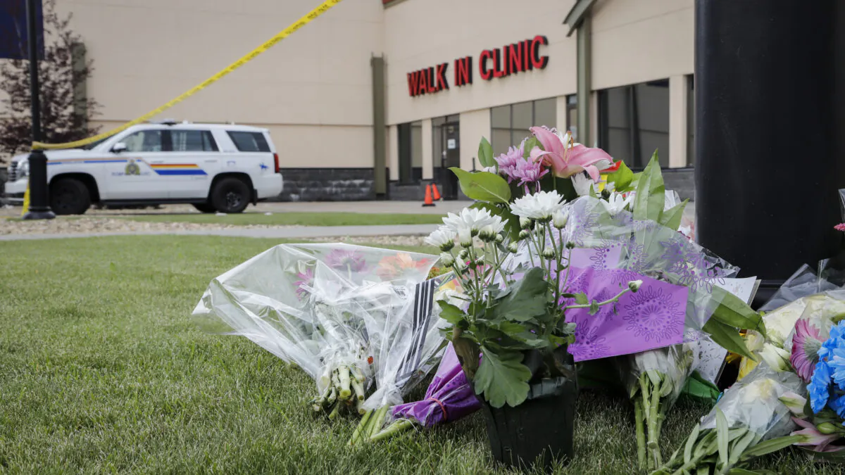 An impromptu memorial for Dr. Walter Reynolds, who died after he was attacked in an examination room rests outside the Village Mall walk-in clinic in Red Deer, Alta., Aug. 11, 2020. (THE CANADIAN PRESS/Jeff McIntosh)