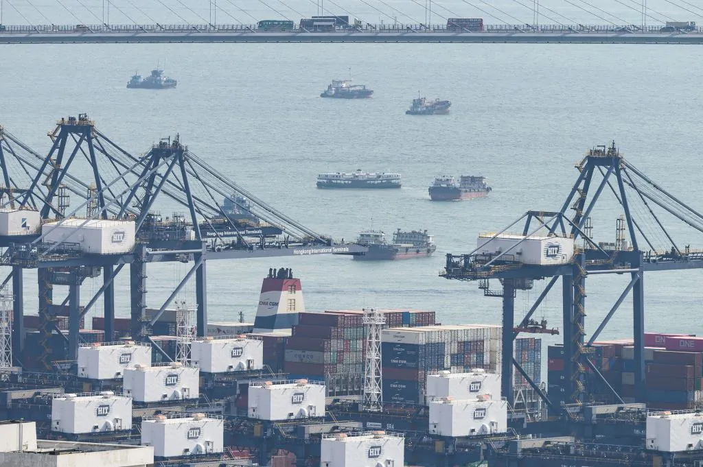 A Star ferry (C) is seen among cargo ships sailing near the Kwai Tsing Container Terminals port facility in Hong Kong on Aug. 20, 2019. (Philip Fong/AFP via Getty Images)