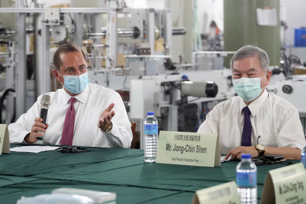 US Secretary of Health and Human Services Alex Azar (L) speaks as Taiwan's Deputy Premier Shen Jong-chin (R) listens during a visit of a mask factory in the Wugu District in New Taipei City on Aug. 12, 2020. (Pei Chen/POOL/AFP via Getty Images)