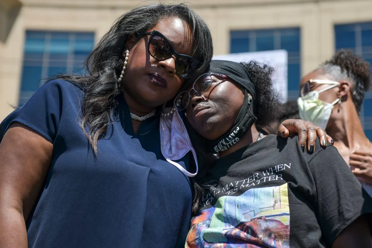 Rep. Leslie Herod (D-Colo.) (L) hugs Elijah McClain's mother, Sheneen McClain (R) as they stand with protesters as they rally outside the Aurora Police Department Headquarters to demand justice for McClain's son in Aurora, Colo., on June 27, 2020. (Photo by Michael Ciaglo/Getty Images)