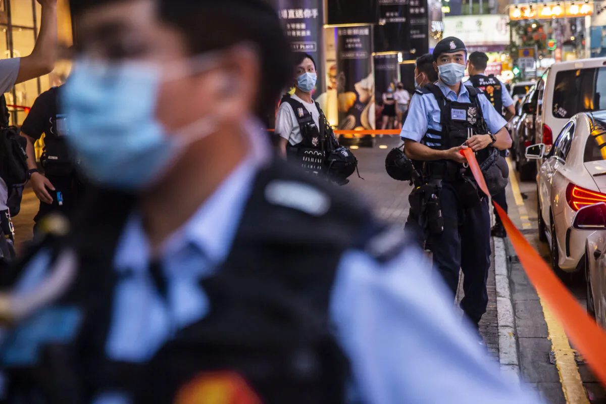 Police set up a cordon outside after people were protesting for press freedom inside a mall in Hong Kong on Aug. 11, 2020. (Isaac Lawrence/AFP via Getty Images)