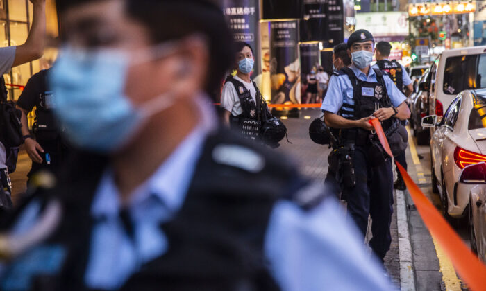 Police set up a cordon outside after people were protesting for press freedom inside a mall in Hong Kong on Aug. 11, 2020. (Isaac Lawrence/AFP via Getty Images)