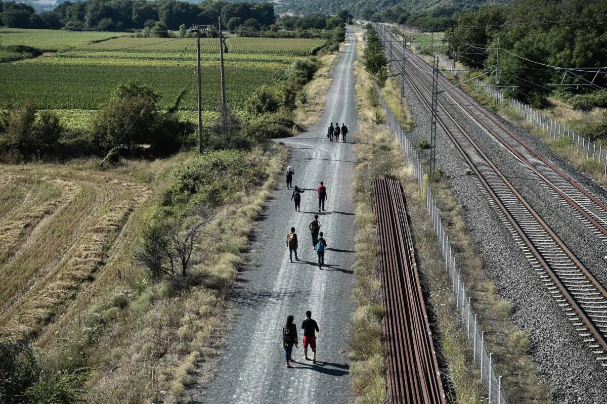 Migrants walk along rail tracks near Idomeni at the border between Greece and North Macedonia, on July 16, 2020. (Sakis Mitrolidis/AFP via Getty Images)