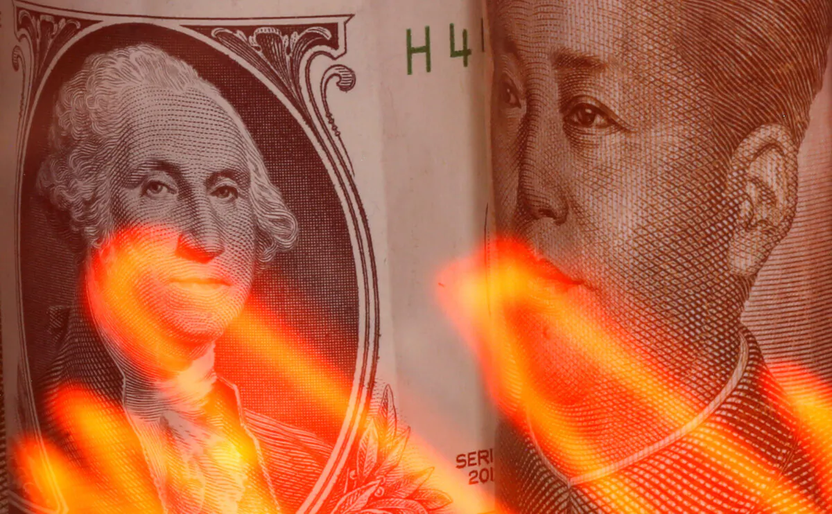 Chinese yuan and U.S. dollar banknotes are seen behind an illuminated stock graph in this illustration taken Feb. 10, 2020. (Dado Ruvic/Illustration/ Reuters)