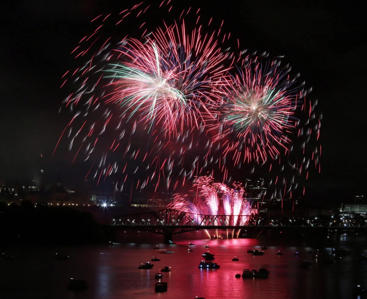 Fireworks explode over the Ottawa River, below Parliament Hill near the Inter-Provincial bridge between Ottawa and Gatineau, Quebec, on Aug. 19, 2017. (The Canadian Press/Fred Chartrand)