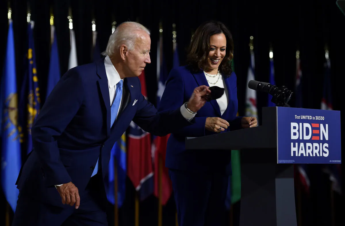 Democratic presidential nominee and former Vice President Joe Biden grabs his mask after introducing his vice presidential running mate, Sen. Kamala Harris, during their first press conference together in Wilmington, Del., on Aug. 12, 2020. (Olivier Douliery/AFP via Getty Images)