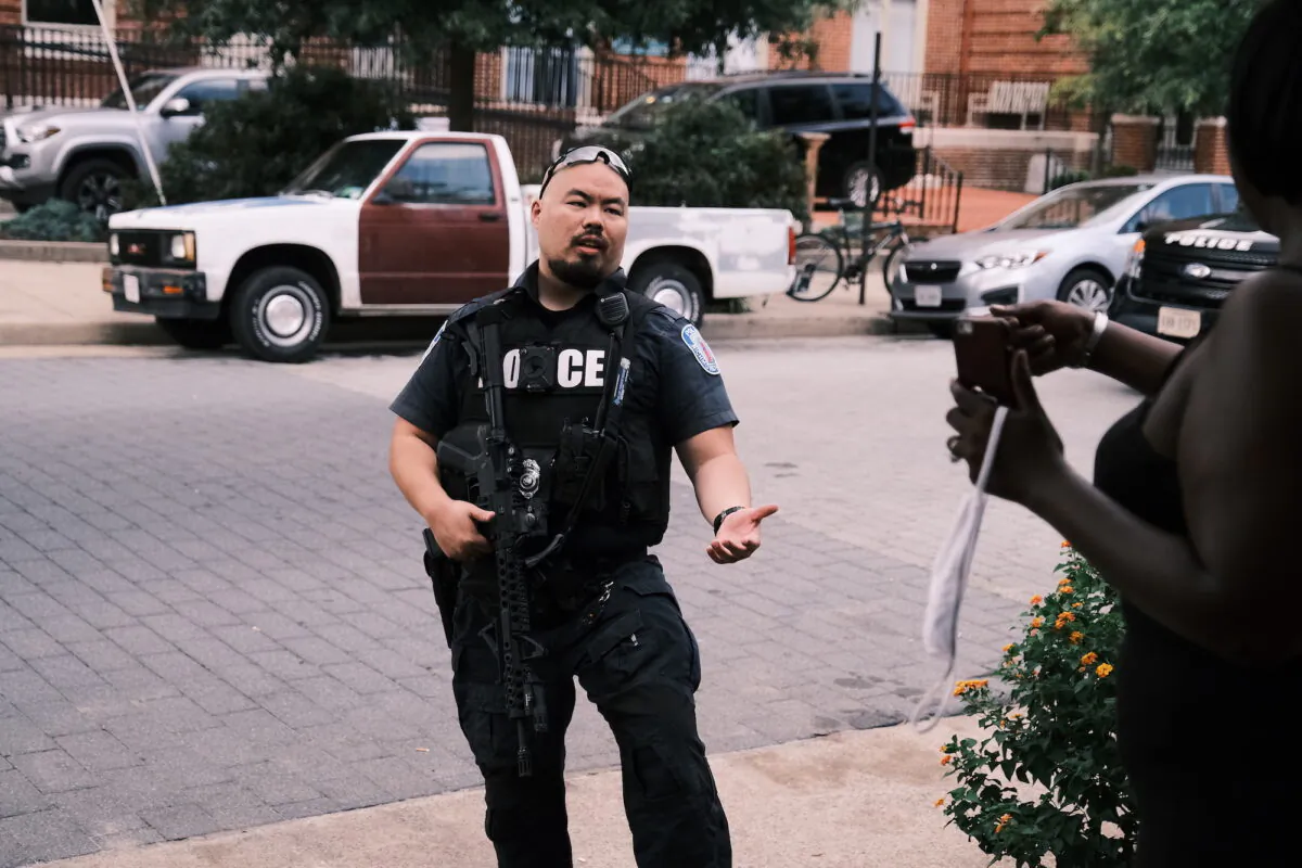A policeman speaks to a bystander in Richmond, Va., on Aug. 8, 2020. (Eze Amos/Getty Images)