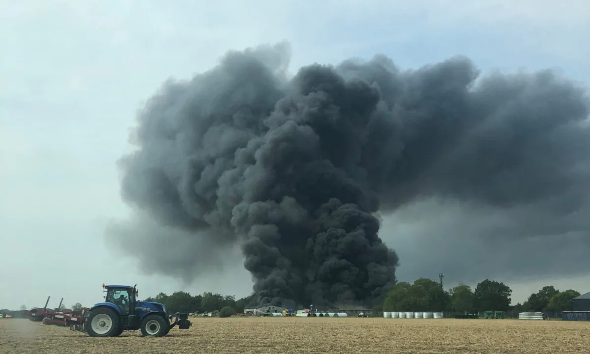 Smoke can be seen after a fire broke out at an industrial unit at Parham Airfield, in Suffolk, England, on Aug. 13, 2020.(Courtesy of Richard Lapage)
