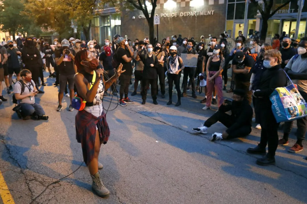 Ariel Atkins, a lead organizer for Black Lives Matter Chicago, leads a protest outside the Chicago Police Department's District 1 station in Chicago, Aug. 10, 2020. (Charles Rex Arbogast/AP Photo)