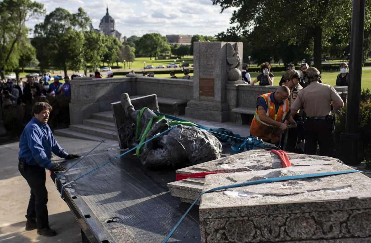 A statue of Christopher Columbus, which was toppled to the ground by vandals, is loaded onto a truck on the grounds of the State Capitol in St Paul, Minn., on June 10, 2020. (Stephen Maturen/Getty Images)
