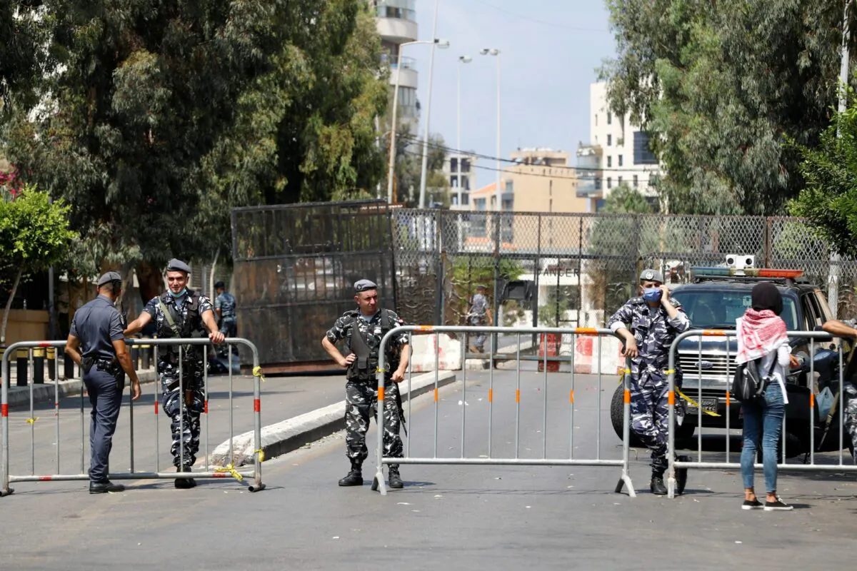 Members of Lebanese security forces block a road to stop protesters from reaching the UNESCO Palace where Lebanon's parliament is holding a session, in the aftermath of a massive explosion in Beirut's port area, in Beirut, Lebanon, on Aug. 13, 2020. (Thaier Al-Sudani/Reuters)
