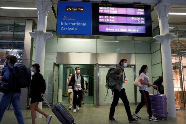 Passengers wearing protective face masks arrive from Paris at Eurostar terminal at St Pancras station, as Britain imposes a 14-day quarantine on arrival from France