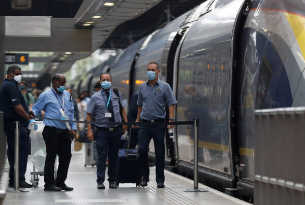 Passengers and staff wearing protective face masks arrive from Paris at Eurostar terminal at St Pancras station, as Britain imposes a 14-day quarantine on arrival from France