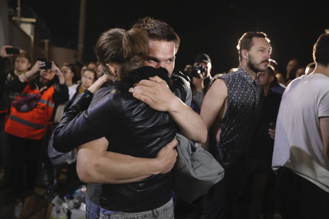 A couple hugs after being released from a detention center where protesters were detained during a mass rally following presidential election in Minsk, Belarus, on Aug. 14, 2020. (AP Photo)
