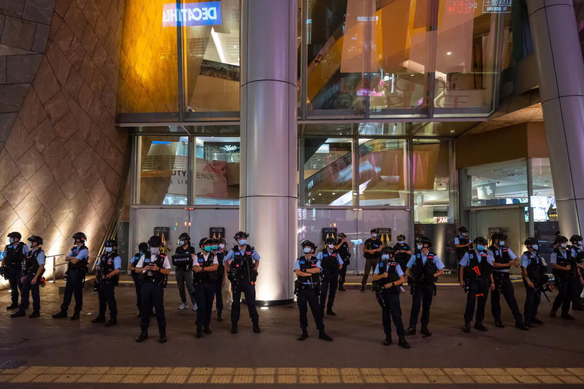 Police stand guard at a mall in Hong Kong after people held a protest for press freedom on Aug. 11, 2020. (Billy H.C. Kwok/Getty Images)