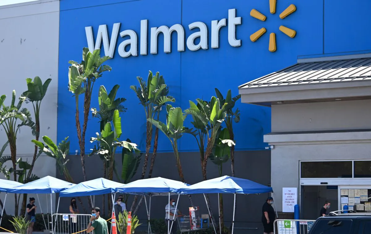 People wearing face coverings wait in line to shop at Walmart in Burbank, Calif., on July 22, 2020. (Robyn Beck/AFP via Getty Images)