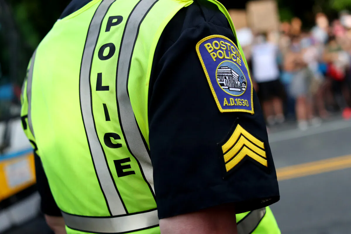 A Boston police officer stands beside a protest in Boston, Mass., on June 4, 2020. (Maddie Meyer/Getty Images)