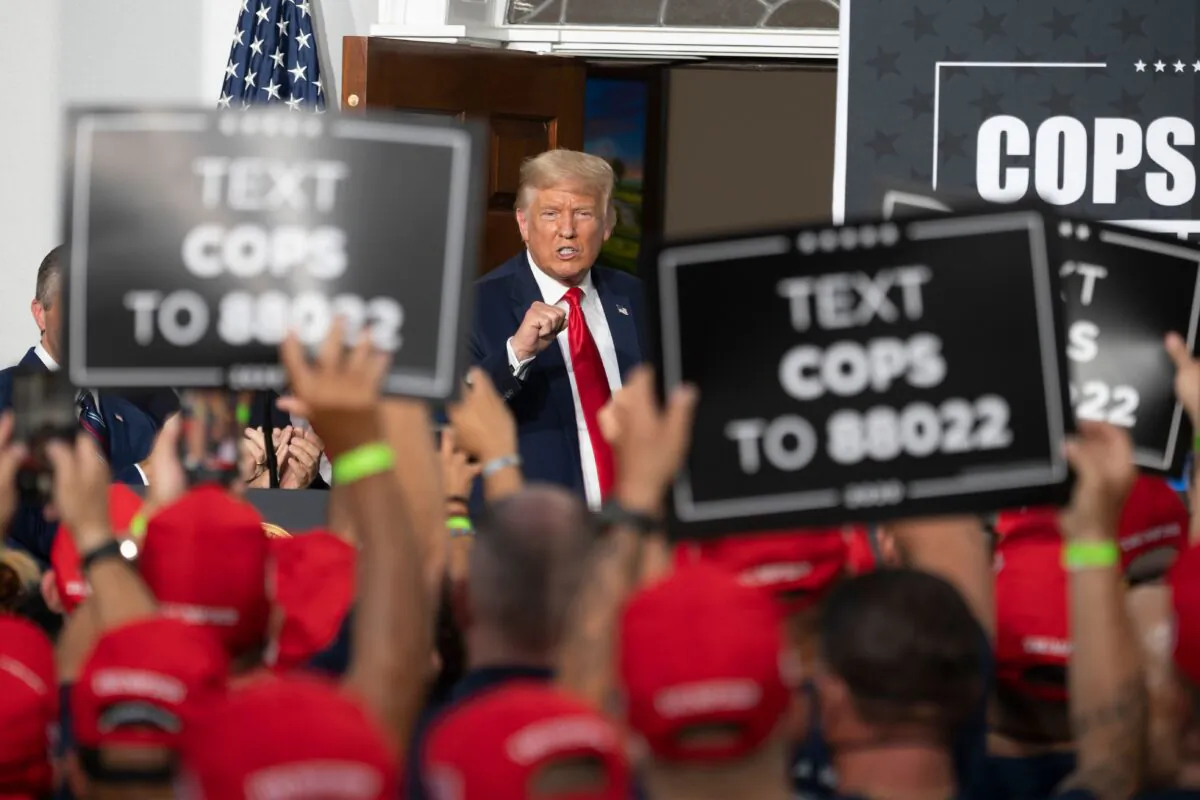 President Donald Trump pumps his fist as he delivers remarks to the City of New York Police Benevolent Association at the Trump National Golf Club in Bedminster, NJ, on August 14, 2020. (Jim Watson/AFP via Getty Images)