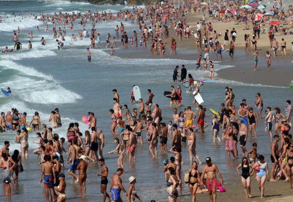 People queue to check-in at the Biarritz airport, southwestern France, on Aug.14, 2020. British holidaymakers in France were mulling whether to return home early Friday to avoid having to self-isolate for 14 days following the U.K. government's decision to reimpose quarantine restrictions on France amid a recent pick-up in coronavirus infections. (Bob Edme/AP Photo)