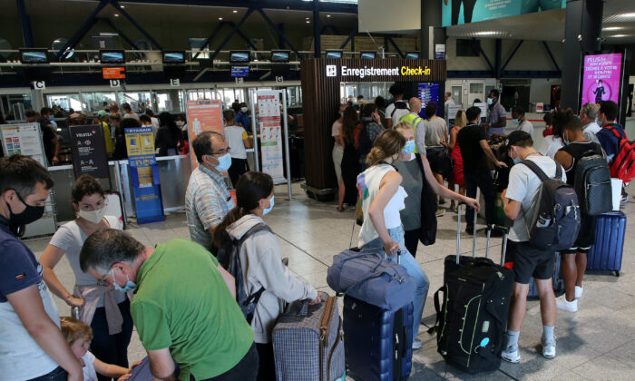 People queue to check-in at the Biarritz airport, southwestern France, on Aug. 14, 2020. (Bob Edme/AP Photo)